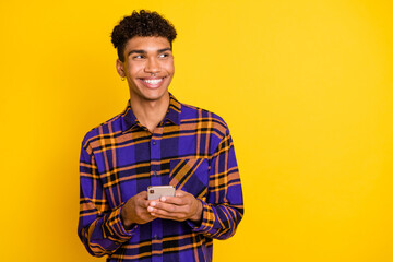 Sticker - Photo portrait of man browsing internet mobile phone looking empty space wearing checkered outfit isolated on vivid yellow color background