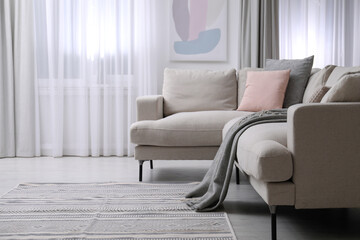 Sticker - Comfortable sofa in stylish living room interior