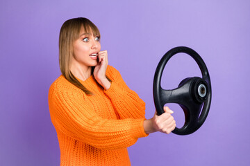 Canvas Print - Profile photo of scared lady driver hold steering wheel bite nail wear orange jumper isolated purple color background