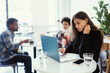 © teksomolika - Portrait of female student using net-book while sitting in cafe