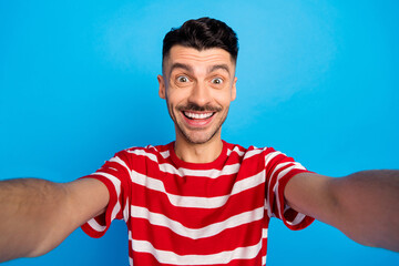 Canvas Print - Photo of cheerful excited young man take selfie camera face isolated on pastel blue color background