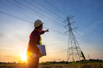 Wall Mural - high voltage, construction electrical engineer or technician standing and watching at the worker che