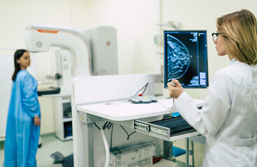 Wall Mural - Young woman is having mammography examination at the hospital or private clinic with a professional female doctor.