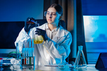 Poster - a chemistry student in the lab. laboratory classes in chemistry. the girl conducts experiments with 