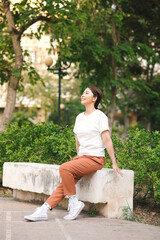 beautiful young woman resting in park