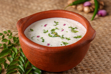 Wall Mural - Spiced buttermilk , chaas , chaach , moru , sambharam , curd, lassi , yogurt, cool refreshing drink for hot summer in a clay pot, Kerala, India. Flavored Indian buttermilk.