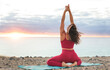 © merla - Woman practicing meditation on a cliff by the ocean at sunrise