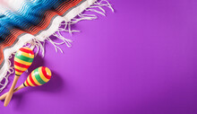 Cinco De Mayo Holiday Background Made From Maracas, Mexican Blanket Stripes Or Poncho Serape On Purple Background.