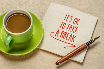 Wall Mural - It is OK to take a break - inspirational handwriting on a napkin with a cup of coffee, self care, stress, overworking concept