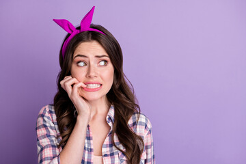 Sticker - Photo portrait of terrified woman biting nails looking at blank space isolated on vivid violet colored background