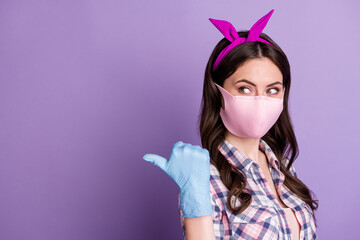 Sticker - Photo portrait of girl wearing protective mask gloves pointing finger blank space isolated on bright violet color background