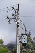 Electricity Rural Wooden Utility Pole With Cables And Insulators In Melbourne Against A Hazy Sky