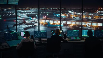 Wall Mural - Diverse Air Traffic Control Team Working in a Modern Airport Tower at Night. Office Room is Full of Desktop Computer Displays with Navigation Screens, Airplane Flight Radar Data for Controllers.