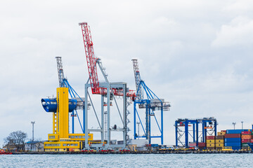 Odessa, UKRAINE - MART 1, 2021. Port cranes stand on the pier. Port cranes are waiting for a vessel to load commercial cargo.