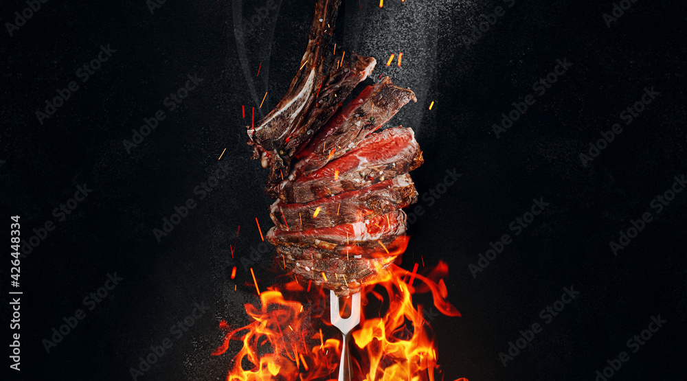 grilled beef steak on a dark background. expensive marbled beef of the highest grade fried to rare on the grill - obrazy, fototapety, plakaty 