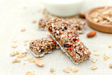 Granola Healthy Snack Bars Granola cereal bar with nuts and berries with yogurt on Sackcloth background