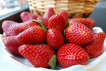 Ripe red large strawberries on a white background