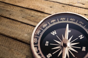brass antique classical compass on wooden desk
