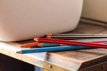 Sticker - Closeup shot of colored pencils on a vintage table