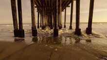 Wide Angle Under Beach Pier As Waves Roll In