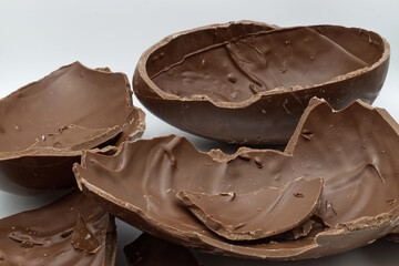 Broken chocolate easter egg in a bowl isolated on white background