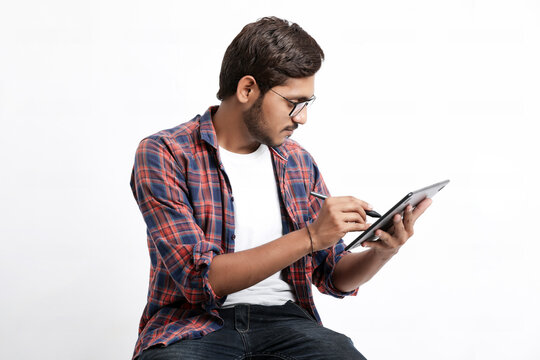 Indian Professional designer using graphic tablet connected to smartphone with digital pen.