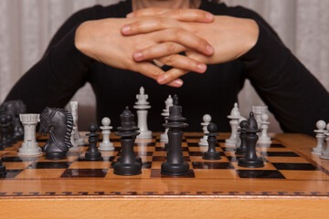 Woman is playing with chess game. Concept of business strategy and tactic.