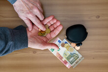 Hands Counting Small Coins. There Is A Wallet And A Euro On The Table.