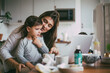 © Maskot - Mother talking with sick son at table in kitchen