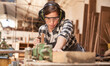 Woman as a carpenter or craftsman in workshop