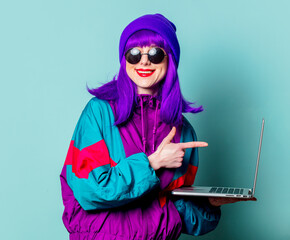 Poster - Smiling white girl with purple hair and 80s tracksuit with laptop on blue background