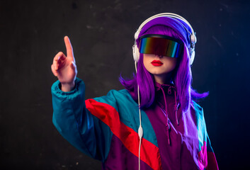 Poster - Stylish girl in cyber punk glasses and 80s tracksuit with headphones on dark background