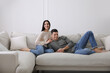 © New Africa - Couple resting on sofa in living room
