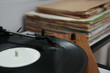 Stylish turntable with vinyl record on table, closeup
