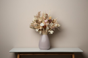 Canvas Print - Beautiful dried flower bouquet in ceramic vase on white table near light grey wall