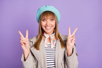 Poster - Photo of lady look camera beaming white smile show two v-signs wear blue beret scarf coat isolated purple color background