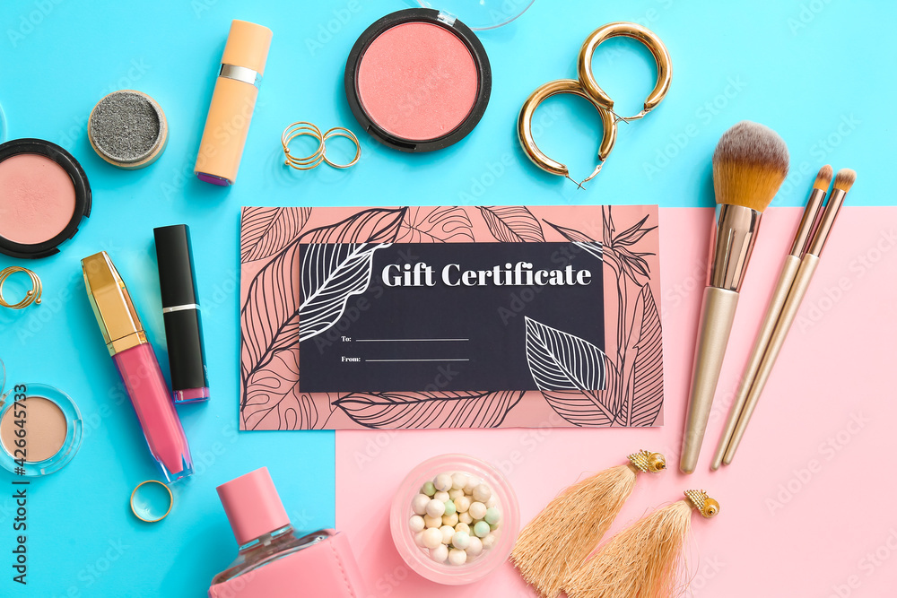 Gift certificate, decorative cosmetics and female accessories on color background