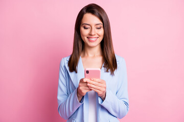 Wall Mural - Photo of young beautiful smiling cheerful positive boss female chatting use phone isolated on pink color background