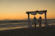 © Wavebreak Media - African american couple in love getting married, walking on beach during sunset holding hands