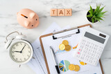 Fototapeta  - Top view of calculating and paying tax concept on marble white table.