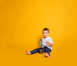 © Julie Boro - child in jeans and a white t-shirt on a yellow background