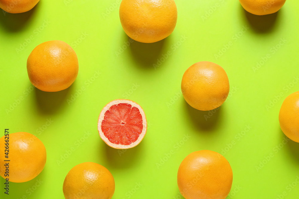 Ripe grapefruits on color background