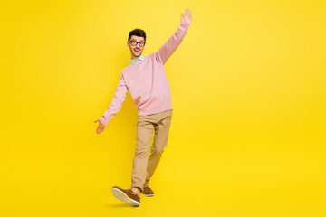 Wall Mural - Full body photo of young excited man happy positive smile have fun dance isolated over yellow color background