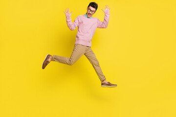 Sticker - Full size photo of young cheerful man happy excited have fun jump up wave hello isolated over yellow color background