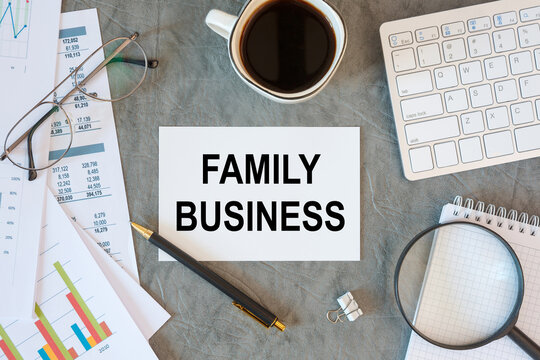 FAMILY BUSINESS is written in a document on the office desk, keyboard and diagram