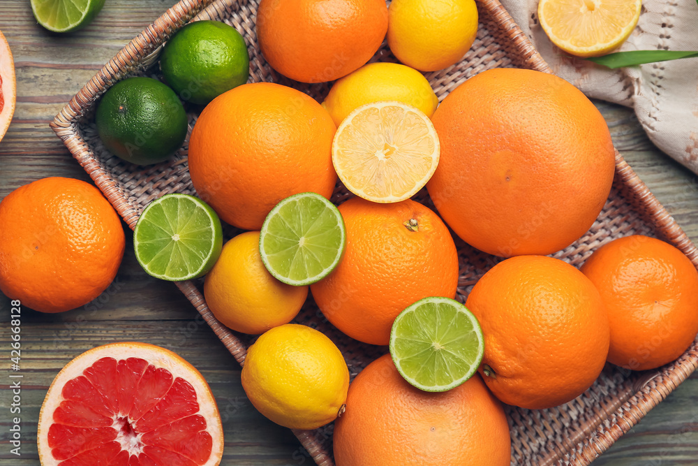 Fresh citrus fruits on wooden background