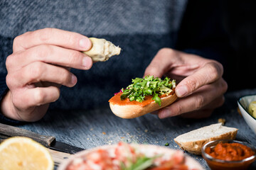 Poster - young caucasian man prepares a vegan appetizer