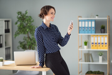 Profile side view portrait of pretty cheerful focused girl using device chatting it project app 5g at work place station indoors