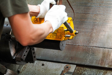 mechanic uses a magnet to lift the workpiece controlled by hand.