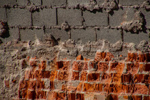 Wall Of Broken Red Bricks And Gray Concrete Hollow Block Bricks